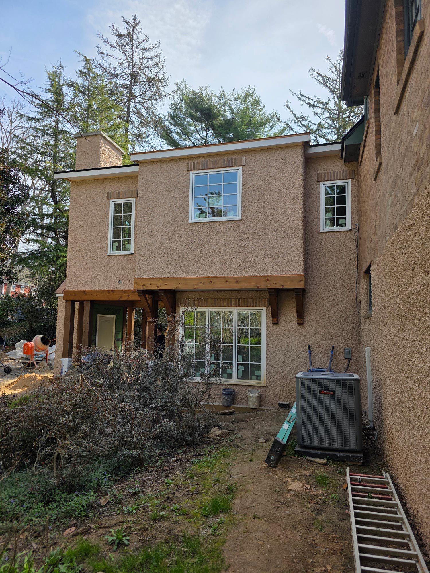 Blending old and new, seamlessly typing the new kitchen addition to the existing structure with textured cement stucco siding Blending old and new, seamlessly typing the new kitchen addition to the existing structure with textured cement stucco siding