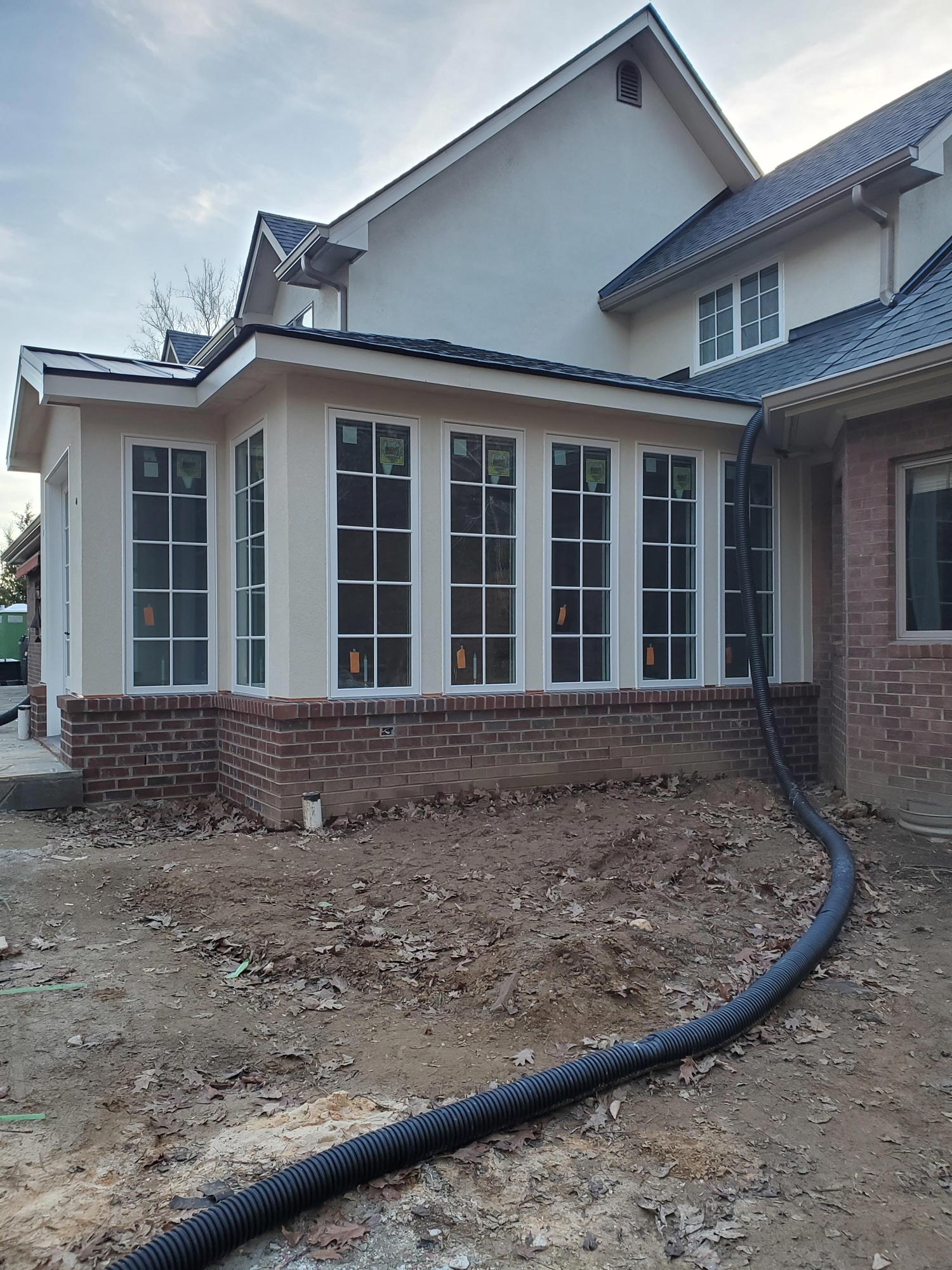 Gutter work to bury downspout for water drainage with new home addition Gutter work to bury downspout for water drainage with new home addition