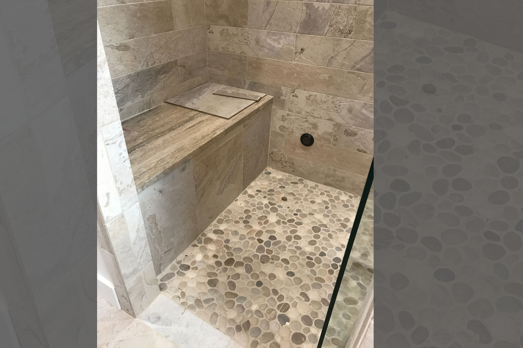 Master bath shower floor with bench and river rock