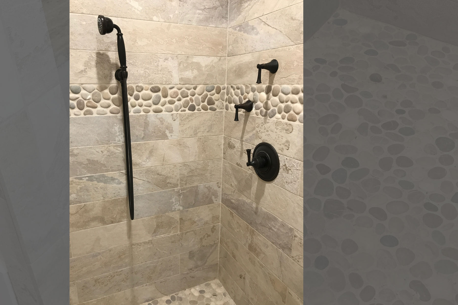 Bathroom renovation with river rock detail in wall tile