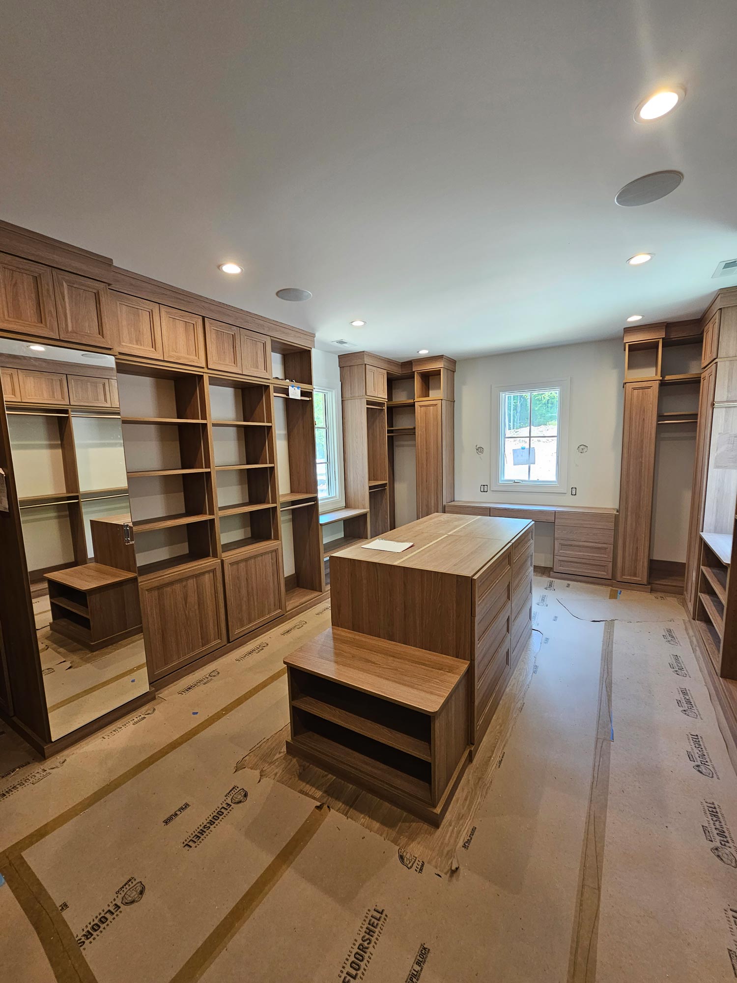 Center island in custom closet with built-in storage