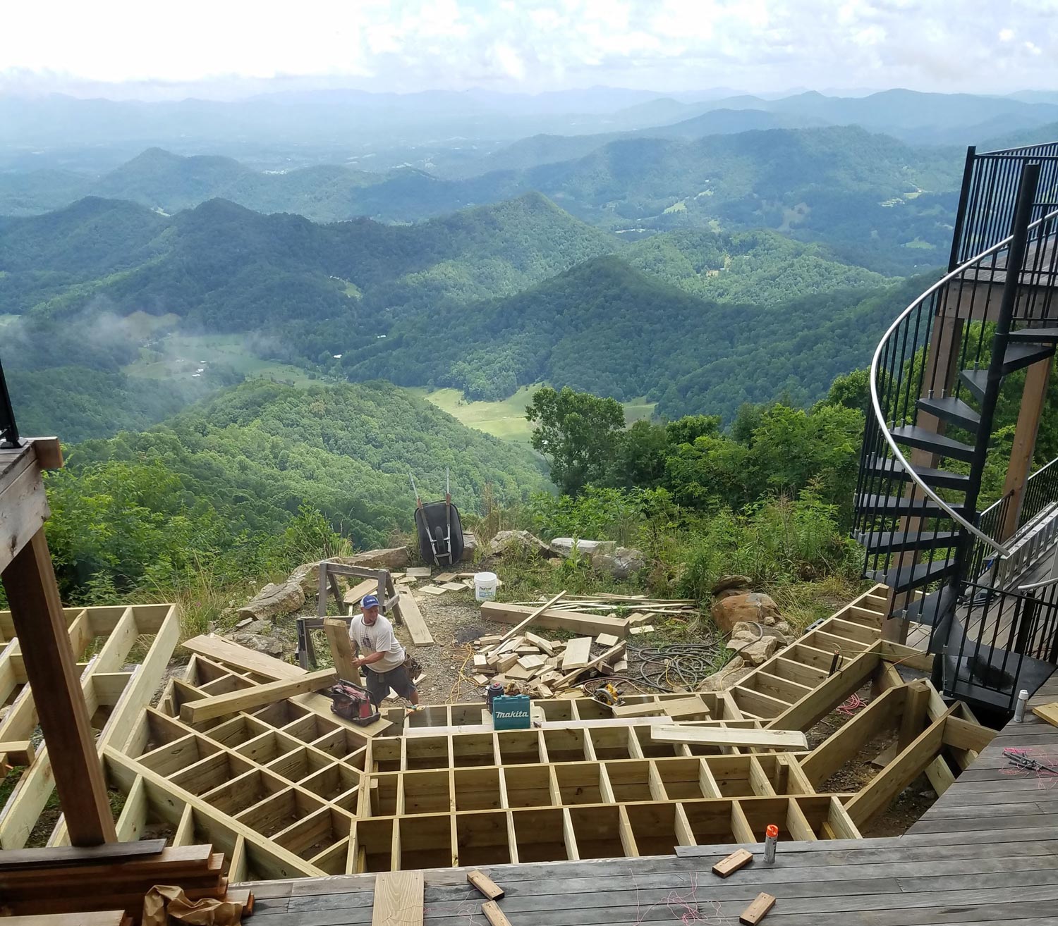 New deck in mountain home with visual angles for design interest and in-set hot tub for enjoying the long range mountain views