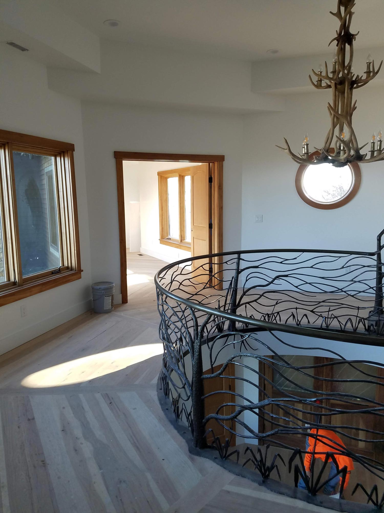 Top of level of three-story circular staircase with custom metal railing Top of level of two-story circular staircase with custom metal railing
